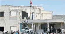  ?? Picture: REUTERS ?? BACK IN CHARGE: Syrian security forces raise the government flag in the main square in Rastan in the central Homs province