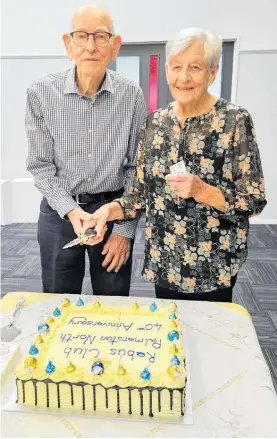  ?? ?? Bryan and Jeanette Cooke cut the Rebus Club of Palmerston North’s 40thannive­rsary cake.