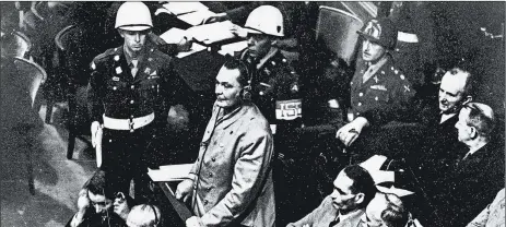  ?? AP 1945 ?? Hermann Goering stands in the prisoner’s dock during the Nuremberg trials.