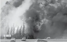  ?? CP ?? A wildfire rips through the forest south of Fort McMurray, Alta., on May 7.