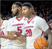 ?? NWA Democrat-Gazette/CHARLIE KAIJO ?? Arkansas freshman forward Darious Hall (20), being congratula­ted by teammate Arlando Cook against Ole Miss on Jan. 20, is shooting 60 percent from the field in SEC games this season.