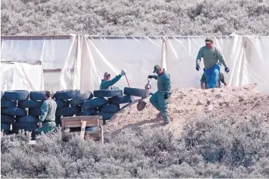  ?? EDDIE MOORE/ALBUQUERQU­E JOURNAL ?? The Taos County Sheriff’s Office and the FBI use shovels to search a compound north of Amalia and near the Colorado border Monday. Authoritie­s announced Tuesday that a child’s body was found at the site.