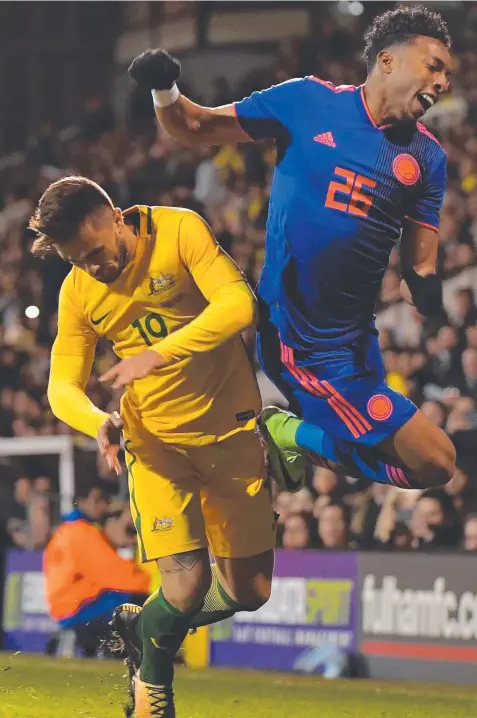  ?? Picture: AFP ?? OBSTACLE: Socceroo Josh Risdon sends Colombian defender Johan Mojica flying at Craven Cottage.