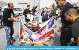  ??  ?? BETHLEHEM: Palestinia­ns stand around an effigy of Arthur Balfour during a protest on the centenary of the Balfour Declaratio­n yesterday. — AP