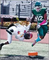  ??  ?? Vallejo High’s Kyree Reason flies through the air asheis brought down in theend zone after a 70-yard touchdown during the Redhawks’ 64-20 loss to Rodriguez.