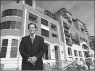  ?? NWA Democrat-Gazette file photo ?? Brandon Barber stands in front of the Legacy Building in Fayettevil­le in 2006. The building was sold at a foreclosur­e auction in 2008.