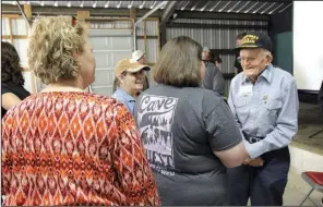  ??  ?? It’s possible to be a rock star at 98, as Elvin Bates demonstrat­ed after his presentati­on on beekeeping at a homesteadi­ng conference in Rison on April 1. Bates extracts and bottles honey from his approximat­ely 100 hives near Monticello.