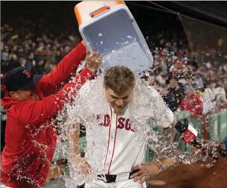  ?? MATT STONE — BOSTON HERALD ?? Red Sox starter Tanner Houck celebrates with his teammates after pitching a complete game shutout to beat the Cleveland Guardians 2-0.