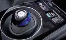  ??  ?? PRACTICALI­TY New e-pedal button sits ahead of the futuristic gearlever, and switches on the Leaf’s regenerati­ve braking system. It’s very effective, and allows you to drive without using the brakes