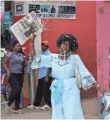  ?? TONNY ONYULO ?? Dorothy Achieng dances along a street in Nairobi, Kenya, during Obama’s visit.