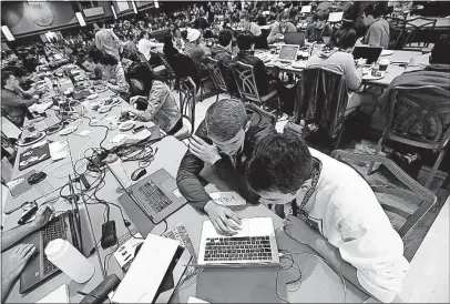  ?? [ANDREA NOALL/DISPATCH] ?? Ohio State sophomores Cory Miller, left, and Danny Freyschlag research ideas Saturday during the annual hackathon in the Ohio Union Grand Ballroom at Ohio State University.