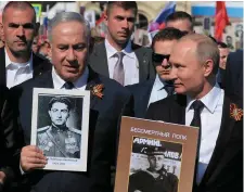  ?? Photo: Alexey Druzhinin/Getty ?? Russian President Vladimir Putin and Israeli Prime Minister Benjamin Netanyahu, left, take part in the Immortal Regiment march in Moscow yesterday.