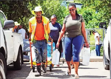  ?? Picture: David Ritchie/African News Agency/ANA ?? HEAVY LOAD: Khanyile “Emmanuel” Siziba assists Parklands resident Ayanda Bingo. Siziba, 30, from Delft, helps people carry their water from the Springs Way spring in Newlands to their vehicles.