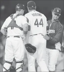  ?? Victor Decolongon
Getty Images ?? DODGERS STARTER Aaron Harang is removed by Manager Don Mattingly in the sixth. Harang gave up five runs in 52⁄ innings. At left is catcher A.J. Ellis.
3