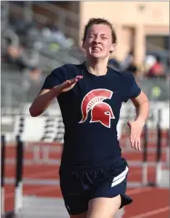  ??  ?? Strathmore High School's Dagny Mcintosh wins the girls 1600-meter race Thursday.