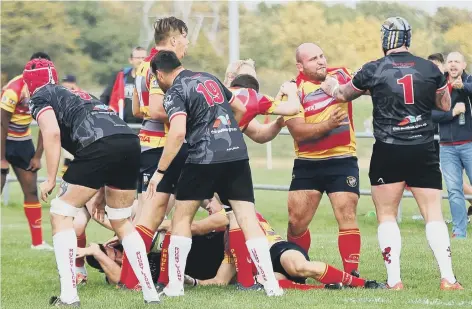  ??  ?? Borough’s Nico Steenkamp grapples with a giant of a Rugby Lions prop.
