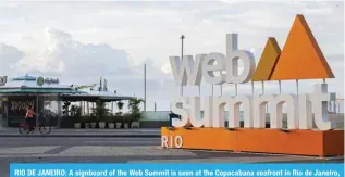  ?? — AFP ?? RIO DE JANEIRO: A signboard of the Web Summit is seen at the Copacabana seafront in Rio de Janeiro, Brazil.