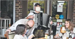  ??  ?? Mike Ditschler, owner of Chef Klaus Bier Stube, serves German cuisine to Porter Place resident Lise Chose at the Tinley Park facility as part of its As You Wish program.