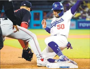  ?? Wally Skalij Los Angeles ?? MOOKIE BETTS beats the tag of Nationals third baseman Nick Denzel in the seventh inning Tuesday at Dodger Stadium. Betts tied his career high with five hits in the Dodgers’ 6-2 win.