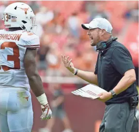  ?? TOMMY GILLIGAN/USA TODAY SPORTS ?? For the second season in a row, Texas and coach Tom Herman, speaking with linebacker Gary Johnson, lost to Maryland.