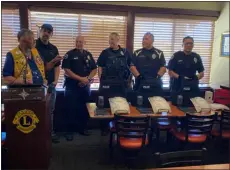  ?? PHOTO COURTESY OF DENNY SOUCEK ?? From left to right, Lions Club District Governor Scott Hayward, Shield616f­ounder Jake Skifstad, Loveland Police Department Interim Chief Eric Stewart, Officer Jon Allen, Officer Benito Avitia and Officer Luis Castellano­s stand at the Loveland Lions Club meeting at Golden Corral in Loveland Oct. 19, 2022. The Lions and Shield616 donated three ballistic vests to the department, a donation project they have done in the past.