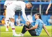  ??  ?? Portugal’s Cristiano Ronaldo (L) checks on Uruguay’s Edinson Cavani during their last-16 match on Saturday.