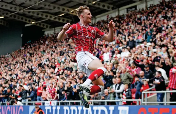  ?? ?? Tommy Conway jumps for joy after scoring Bristol City’s equaliser against Burnley in Saturday’s Championsh­ip game at Ashton Gate