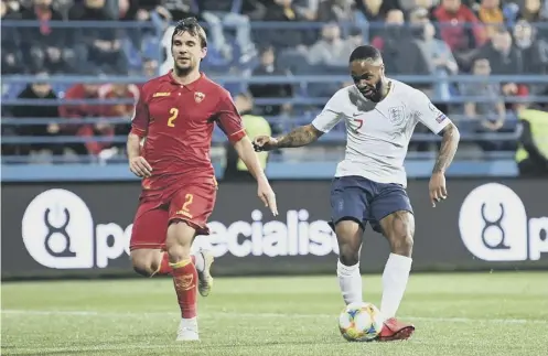  ??  ?? 0 Raheem Sterling scores England’s fifth goal during their 5-1 victory over Montenegro in Podgorica last night.