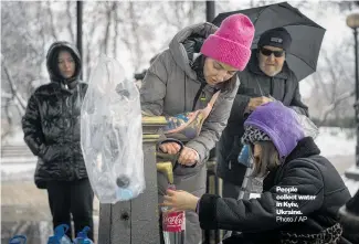  ?? Photo / AP ?? People collect water in Kyiv, Ukraine.