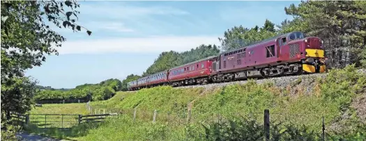  ?? MARK PIKE. ?? West Coast Railway 37518 passes Creech Bottom, south of Worgret Junction, with the 1319 Wareham-Swanage on June 13 2017. 33012 was on the rear. This was the first day of main line trains between Swanage and Wareham, however they will not run this...