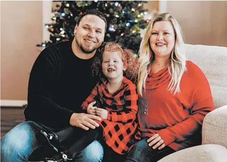  ?? JADE WARE ?? Mindy Jones, with husband, Nick, and daughter Gracelyn, has put up several Christmas trees in their new Kentucky home.