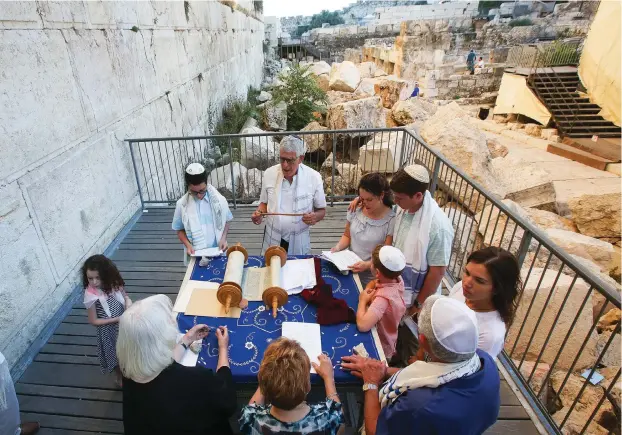  ??  ?? AN AMERICAN family celebrates a bar mitzvah last summer in the Azarat Yisrael plaza at the Robinson’s Arch archaeolog­ical site at the southern end of the Western Wall.