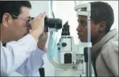  ?? LYU SHUAI / XINHUA ?? A Chinese ophthalmol­ogist examines a patient at China-Ethiopia Friendship Hospital in Addis Ababa, Ethiopia, on Friday as part of a yearlong free assistance project. A Chinese medical team went to Ethiopia last year to carry out the program.