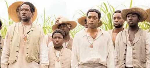  ?? Francois Duhamel Fox Searchligh­t ?? DWIGHT HENRY, left, and Chiwetel Ejiofor, middle right, in “12 Years a Slave,” which clearly depicts slavery’s horrors.