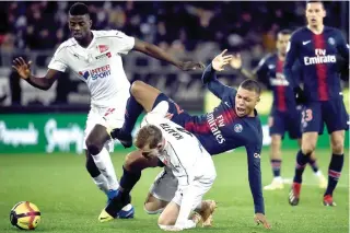  ?? AFP PHOTO MANCHESTER, UK: ?? Paris Saint- Germain’s forward Kylian Mbappe (second from right) fights for the ball with Amien’s defender Emil Krafth (center) during the French L1 football match at the Licorne stadium in Amiens.