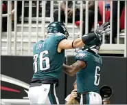  ?? BRYNN ANDERSON — THE ASSOCIATED PRESS ?? Philadelph­ia Eagles wide receiver DeVonta Smith (6) celebrates his touchdown catch with Philadelph­ia Eagles tight end Zach Ertz (86) during the first half of an NFL football game against the Atlanta Falcons, Sunday, Sept. 12, 2021, in Atlanta.