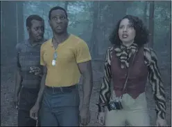  ?? WARNER MEDIA ?? George (Courtney B. Vance, left), Tic (Jonathan Majors) and Leti (Jurnee Smollett) encounter otherworld­ly danger in the forest in HBO’s “Lovecraft Country.”