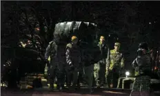  ??  ?? Army ROTC cadets from Duquesne University carry a large tire as a part of the physical training session.