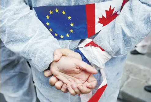  ?? FRANCOIS MORI / THE ASSOCIATED PRESS FILES ?? An activist demonstrat­es against the EU trade deal with Canada, known as CETA, in 2016. France’s ambassador to Canada, Kareen Rispal, said it is better to let Europeans see the benefits of the deal slowly instead of rushing into a debate about its merits before EU elections in the spring.