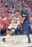  ?? Ap-timothy D. Easley ?? Louisville forward Jordan Nwora (33) attempts to drive past the defense of Akron center Deng Riak (10) during the second half of an NCAA college basketball game in Louisville, Ky., on Sunday.