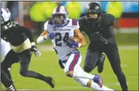  ?? Arkansas Democrat-Gazette/Thomas Metthe ?? OFFENSIVE END: Arkadelphi­a senior running back Zion Hatley (24) runs past Joe T. Robinson defensive end Zach Williams (56) Saturday during the third quarter of the Badgers’ 28-0 win over the Senators in the Class 4A state championsh­ip game at War Memorial Stadium in Little Rock.