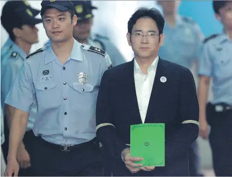  ?? AHN YOUNG-JOON/AFP/GETTY IMAGES ?? Lee Jae-yong, centre, vice-chairman of Samsung Electronic­s and heir to the business empire, arrives for his trial in Seoul on Monday. Lee, who has denied all bribery-related charges, may be the first in his family to serve a prison term if convicted.