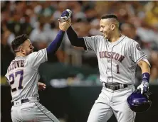  ?? Ben Margot / Associated Press ?? Carlos Correa, right, twice celebrated with Jose Altuve after clubbing homers Thursday, including the 100th of his career.