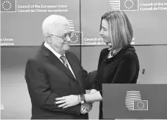  ??  ?? Mahmud Abbas is welcomed by Mogherini prior to attend a EU foreign affairs council at the European Council in Brussels. — AFP photo