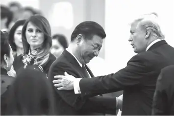  ?? ASSOCIATED PRESS ?? China’s President Xi Jinping, US President Donald Trump and first lady Melania Trump attend a state dinner at the Great Hall of the People in Beijing, China.