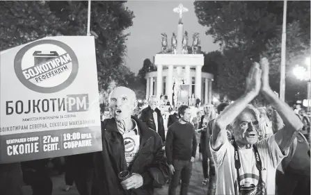  ?? THANASSIS STAVRAKIS THE ASSOCIATED PRESS ?? Protesters who had urged voters to boycott Sunday’s referendum demonstrat­e in Skopje, Macedonia. Voter turnout was a tepid 34 per cent.