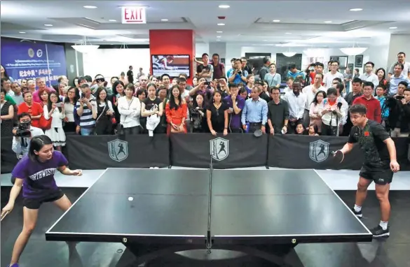  ?? PHOTOS BY WANG PING / XINHUA ?? Wang Hao (right), a world ping-pong champion, played an exhibition match recently in Chicago.