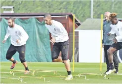  ??  ?? TURIN: From left, Juventus’ Gonzalo Higuain, Leonardo Bonucci and Moise Kean attend a training session ahead of today’s Champions League, Group H soccer match against Lyon, in Turin, Italy, yesterday. — AP