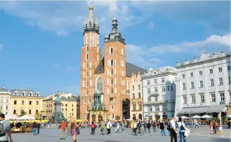  ?? CAMERON HEWITT ?? Krakow’s main square offers a vibrant slice of modern Polish life — and it’s just steps away from a cheap and cheerful milk-bar meal.