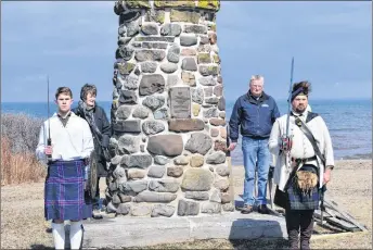  ?? FRAM DINSHAW/ THE NEWS ?? Several residents of Pictou County stand guard at the Culloden Cairn, commemorat­ing the pivotal historical battle between the British crown and the Scottish Jacobite Rising.